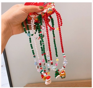 Detailed view of handmade Christmas beaded necklaces for kids with festive holiday charms