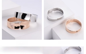 Polished silver and rose gold wide cuff bracelets with spring clasp detail
