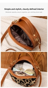 Detail view of the interior capacity showing a brown leopard print round crossbody bag