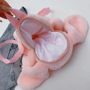 Detail showing the internal storage space and lining of the pink plush teddy bear backpack