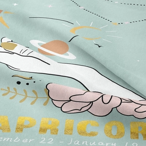 Detail of Capricorn zodiac tapestry featuring Capricorn text and dates on blue fabric