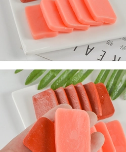Detailed view of realistic PVC faux food slabs for DIY keychains on a ceramic plate