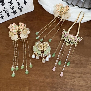 Close-up of Chinese style butterfly hair clips and tassel hairpins with floral oil drip