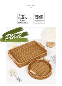 Detailed view of handmade woven storage baskets with dual wood handles on a white desk