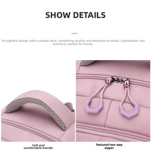Detailed view of pink school backpack with padded mesh handle and dual metal zippers