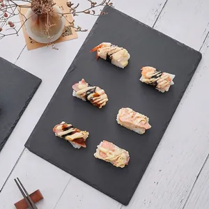 Natural rectangular black slate sushi plate with raw edges for steak and snacks