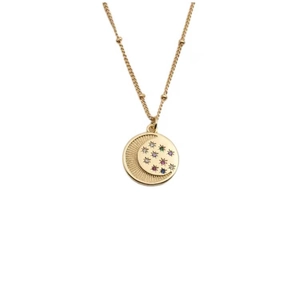 Golden necklace featuring a round moon and star pendant with colorful zircon stones