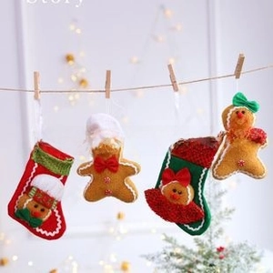 Hanging Christmas gingerbread man and stocking ornaments set on rustic jute twine