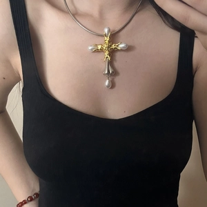 Vintage gold and silver cross pendant necklace with pearls and snake chain on model