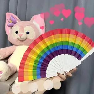 Detail of colorful rainbow folding fan showing vibrant fabric stripes and white frame