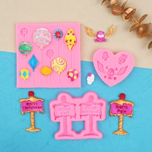 Detail showing pink silicone molds with Merry Christmas road sign and balloon shapes