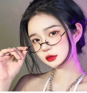 Close-up of black metal half-rim glasses worn by a model with stylish silver chain