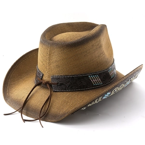 Detail of western straw cowboy hat with embroidered floral patterns and leather band