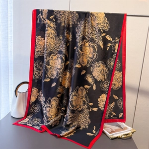 Elegant floral silk scarf with gold flower print on black and red border accent