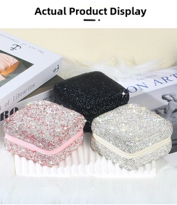 Detailed view of square rhinestone jewelry organizers in black, pink, and silver colors