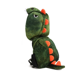 Detail of green plush dinosaur backpack featuring orange spikes and a matching hood