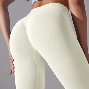 Close-up of seamless high-waisted yoga pants in cream white with ribbed texture and peach lift