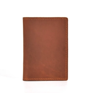 Retro brown crazy horse leather coin purse with handmade stitching on white background