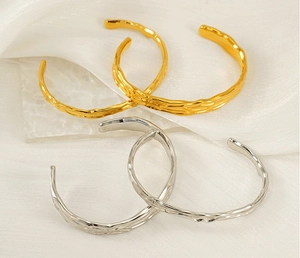 Macro detail of gold and silver irregular lava texture stainless steel bracelets