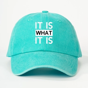 Front view of turquoise washed baseball cap featuring the slogan IT IS WHAT IT IS