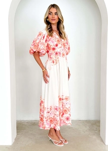 Detailed close-up of V-neck floral midi dress with puff sleeves and vibrant pink flower patterns