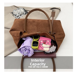 Top view of spacious brown matte tote bag interior showing large capacity and storage details