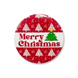 Macro view of 58mm tinplate Christmas badge with Merry Christmas text and tree