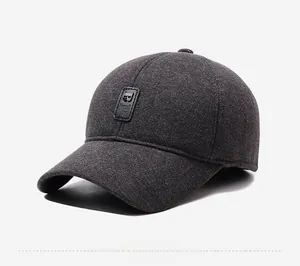 Detail view of dark grey winter baseball cap with wool texture and metal B logo