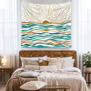 Bohemian sun tapestry with golden rays and teal waves hanging above a wooden bed