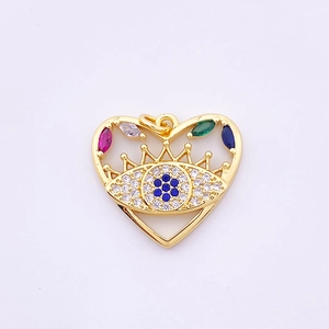 Detailed close-up of golden heart-shaped Evil Eye pendant with colorful zircon stones