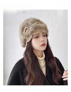 Detail of light khaki hand-crocheted octagonal hat with thick faux fur trim for winter