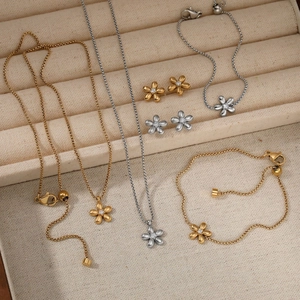 Stainless steel flower jewelry set with necklaces, earrings, and bracelets in a gift box