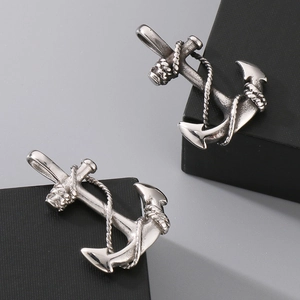 Detailed close-up of silver anchor pendant with vintage rope texture on black cube