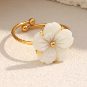 Macro detail of 18K gold plated flower ring with white shell petals and adjustable band