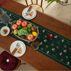 Dark green Christmas table runner with Santa Claus jacquard on a wooden dining table
