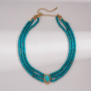 Detail of bohemian three-layer turquoise beaded necklace with adjustable gold chain