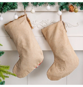Rear view of two khaki burlap Christmas stockings with brown fur trim on a white mantel