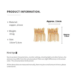 Detail view of gold tassel earrings with zircon cross showing size and dimensions