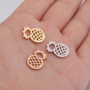 Hollow pineapple pendants in gold, silver, and rose gold finishes on mirror stainless steel