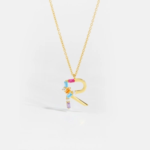 Detailed close-up of golden S925 silver necklace featuring a colorful zircon letter R pendant