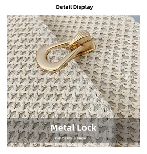 Detailed macro view of the cream woven texture and golden metal buckle on the crossbody bag