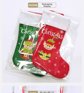Detail of red and green felt Christmas stockings with elf characters in plastic packaging