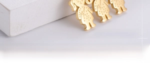 Macro shot of three gold-plated character charms with Love engraving in stainless steel