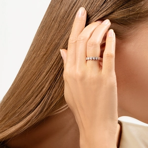Close-up of elegant 925 sterling silver heart-shaped eternity ring on model hand