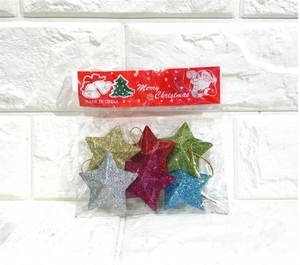 Close-up of colorful glitter star ornaments for Christmas tree in clear plastic packaging
