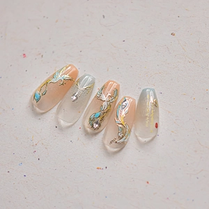 Detail of phoenix embroidery nail stickers with gold relief and sparkling crystal accents