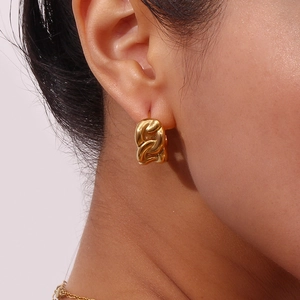 Minimalist gold stainless steel semi-circle chain hoop earrings worn on female ear