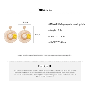 Detailed size and weight specs for handmade raffia straw hat earrings with yellow floral art
