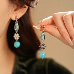 Vintage silver flower drop earrings with turquoise stones and bohemian tassel design