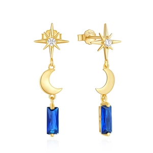 Macro shot of S925 silver gold-plated earring with blue gem and star-moon details